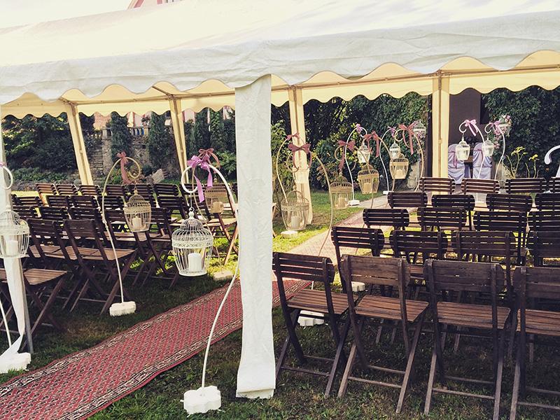 Marquee prepared for a ceremony with wooden chairs